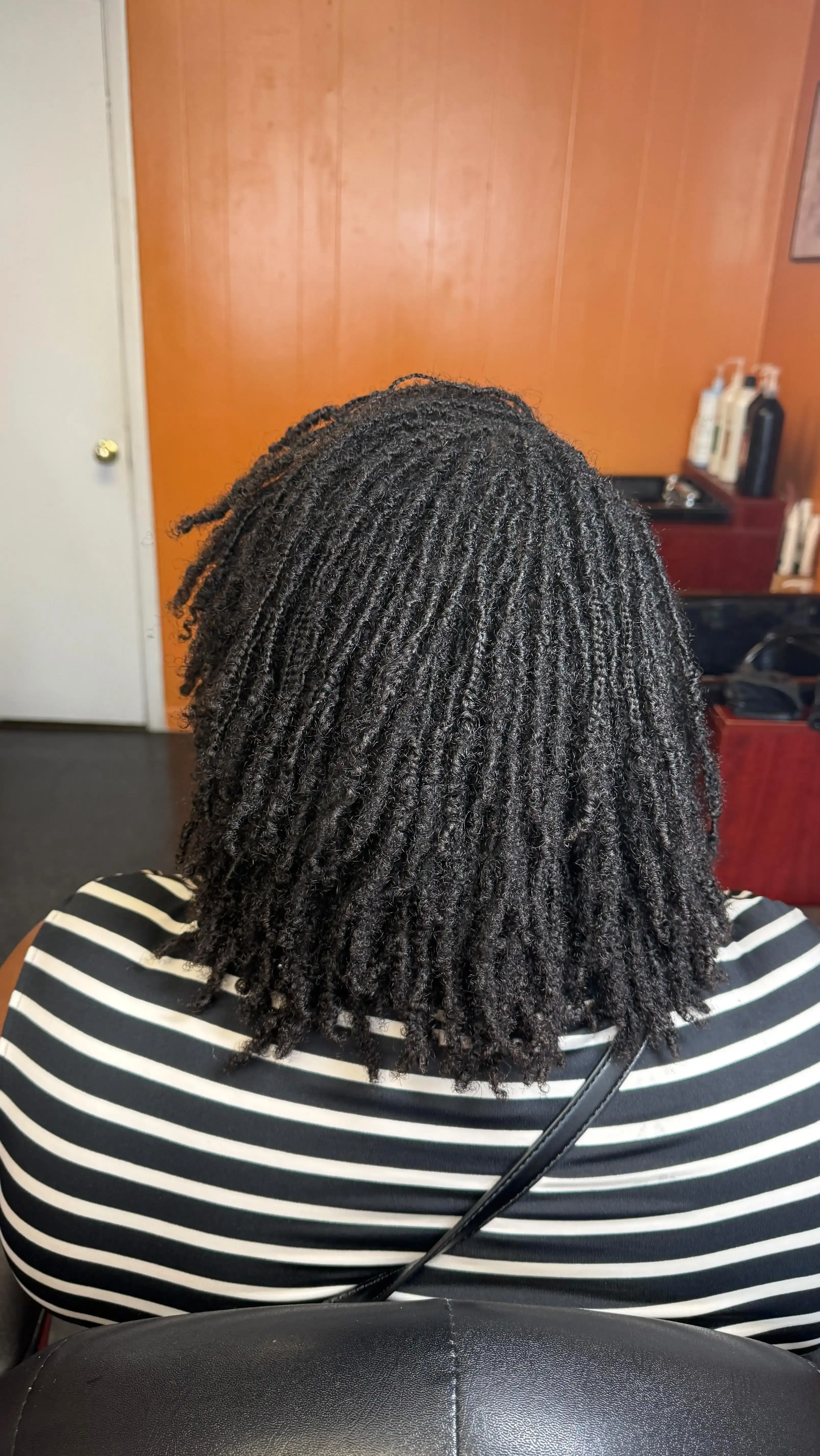First loc retightening session — well-maintained locs after initial installation