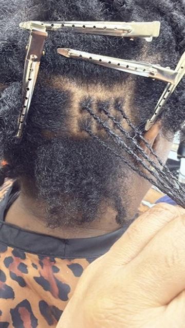 Consultation session assessing hair texture and discussing interlock 4-point rotation technique