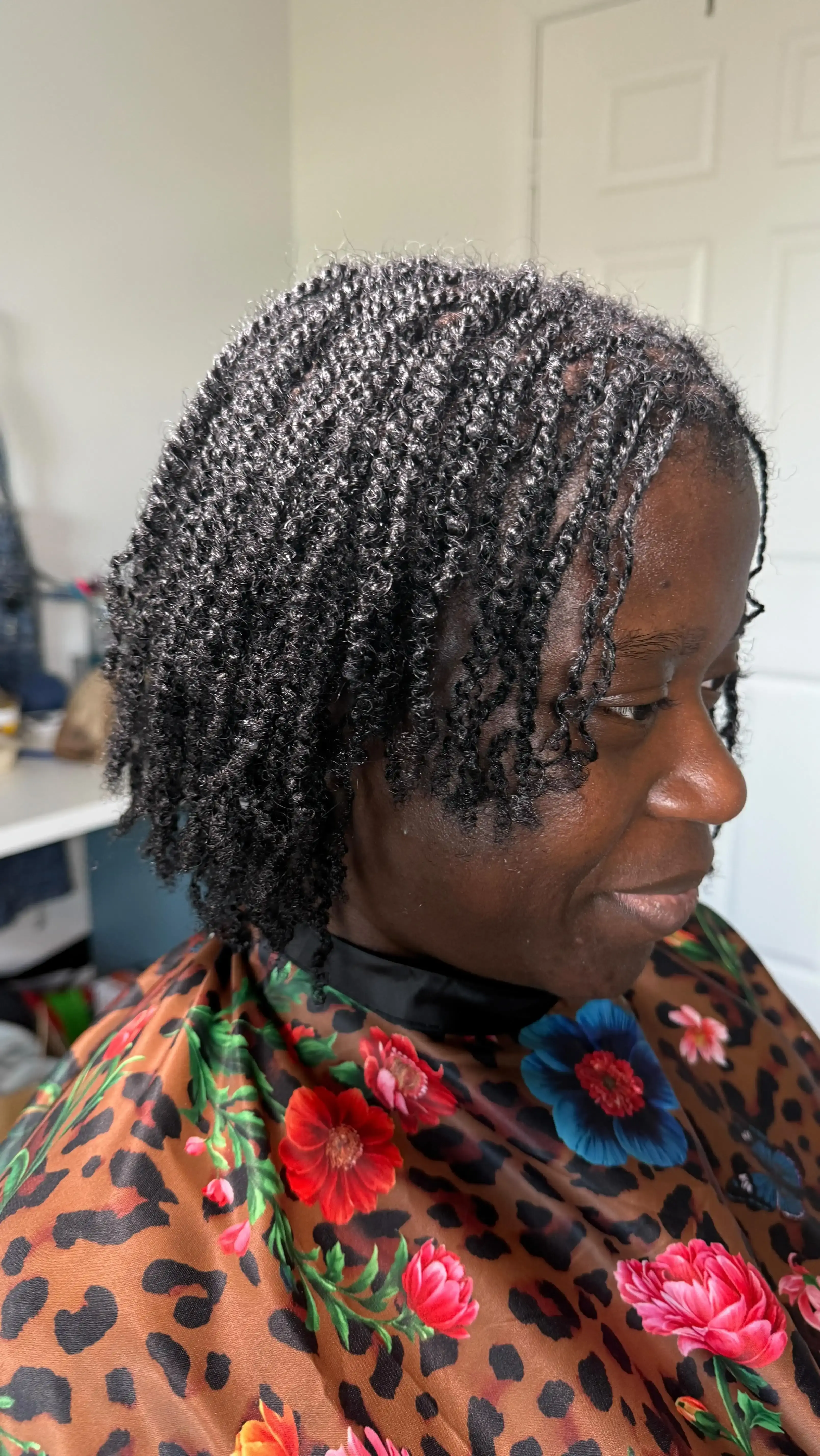 Client with long dark locs against deep navy backdrop showing beautiful loc length