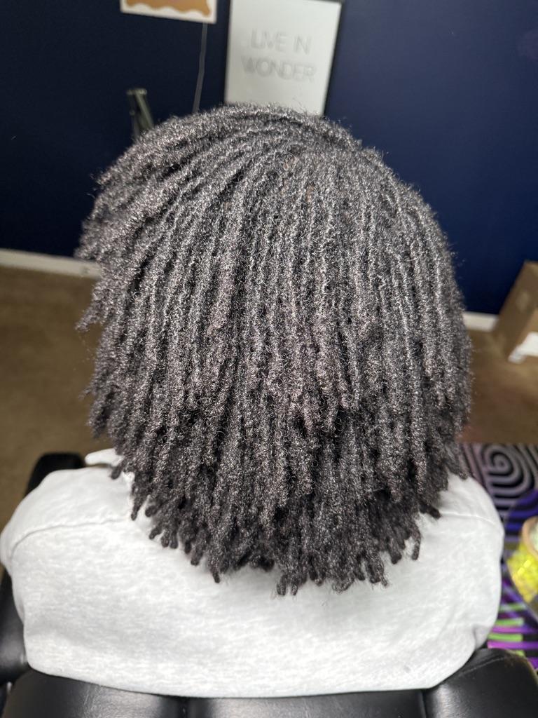 Client showcasing beautiful loc results at Locs By Steph B